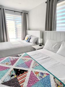 a bedroom with two beds with a quilt on them at The View suites and breakfast in Triton, Newfoundland in Pilleyʼs Island
