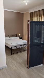 a bedroom with a bed and a tv in it at Beachfront Apartment in Nea Moudania