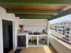 a balcony with a stove on top of a building at Almadraba Suite Ático duplex in Zahara de los Atunes