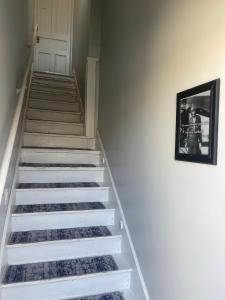 a stairwell with white steps and a picture on the wall at St Pete Vacation Rentals in St. Petersburg