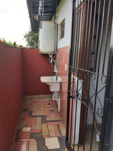 a bathroom with a toilet and a sink at DON MIGUEL DEPARTAMENTOS in Puerto Iguazú