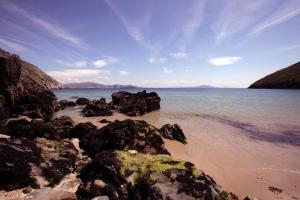 a beach with some rocks in the water at Sona Baile Home Stay in Dooagh