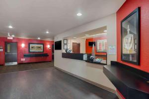 a large room with red walls and a lobby at Extended Stay America Suites - Orange County - Lake Forest in Foothill Ranch