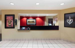 a waiting room with a mirror and a television at Extended Stay America Suites - Columbus - Bradley Park in Columbus