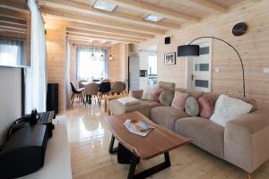a living room with a couch and a table at FüredIKON*** in Tiszafüred