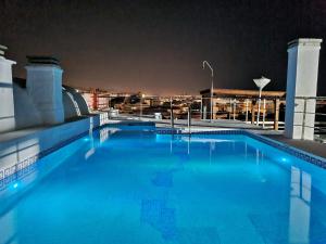 una piscina en la parte superior de un edificio por la noche en Penthouse with private pool, hot tub jacuzzi with sea views and chill-out zone, close to the sea, en Marbella