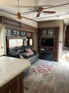 an rv living room with a couch and a table at Gorgeous Denali 5th Wheel Delight! in Walla Walla