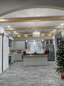 a large kitchen with a christmas tree in the middle at La Casa Grande Hosting in Whitsett