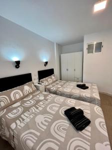 a bedroom with two beds and a large bed sidx sidx sidx at Ducado 41 Playa in Benidorm +21 photos