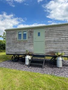 a tiny house with a picnic table in front of it at The Woolly Sheep Shepherd Huts in Whitland