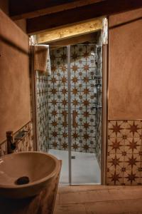 a bathroom with a shower with a sink and a tub at Susurros del Manadero in Robledillo de Gata +18 photos