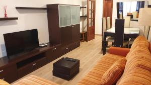 a living room with a couch and a flat screen tv at Fogar Oeste in Vilagarcia de Arousa
