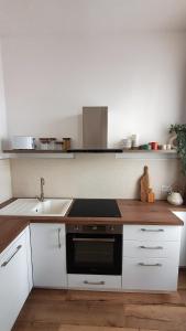 a kitchen with a sink and a stove top oven at Appartement au calme T3 RDC - Quartier de France in Vichy