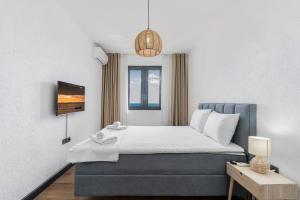 a hotel room with a bed and a window at Vista Seaview in Sveti Stefan