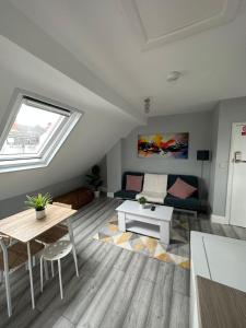 a living room with a table and a couch at DVM escape Flat 3 in Bristol