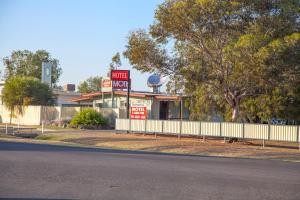 a motel with a sign in front of a building at Mitchell Motel & Cabins in Mitchell