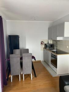 a kitchen with a table and chairs in a room at Oaza mira in Zlatibor +8 photos