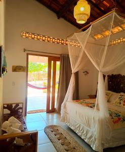 a bedroom with a bed with a canopy at Flats Macapá Meu Amor in Luis Correia