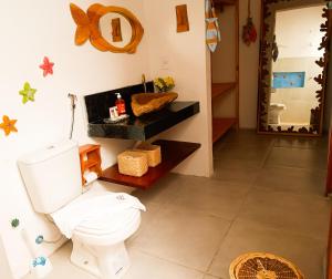 a bathroom with a white toilet and a mirror at Flats Macapá Meu Amor in Luis Correia