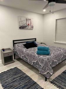 a bedroom with a bed with blue pillows on it at Lovely 2-beds Central Clearwater Apartment in Clearwater