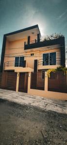 a house with a fence in front of it at Villa De Santos Acapulco Playa Bonfil Alberca in Acapulco