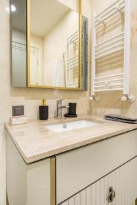 a bathroom with a sink and a mirror at Upscale Istanbul Accommodation with Top-Notch Amenities in Istanbul