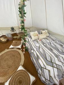 a bed in a room with pillows at Country Bumpkins Luxury Glamping in Wellingore
