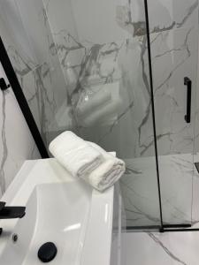 a bathroom with a white towel on a sink at AirPort Apartment in Warsaw