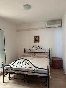 ein Bett in einem Schlafzimmer mit einer weißen Wand in der Unterkunft Perla Marina in Capitolo