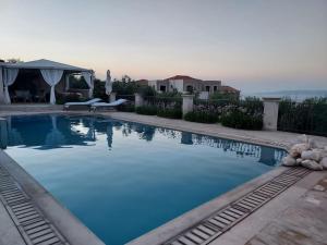 a large swimming pool with a teddy bear laying next to it at Nicol's view in Prasás