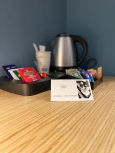 a card sitting on a table with a tea kettle at RESIDENZA 62 in Rome