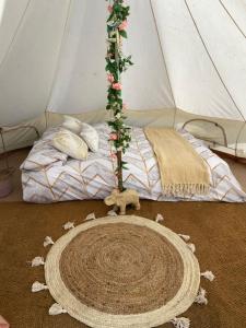 a room with a tent with a bed and a rug at Country Bumpkins Luxury Glamping in Wellingore