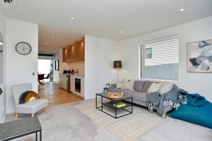 a living room with a couch and a table at Worcester Terrace Eleven - Christchurch Holiday Homes in Christchurch