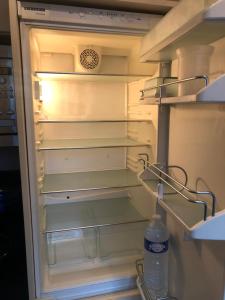 an open refrigerator with a bottle of water in it at Hyper centre - Balcon / Parking in Le Havre