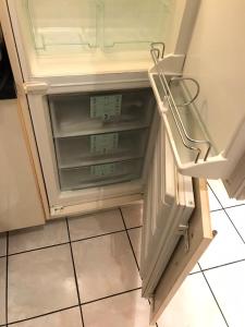 a refrigerator with its door open in a kitchen at Hyper centre - Balcon / Parking in Le Havre