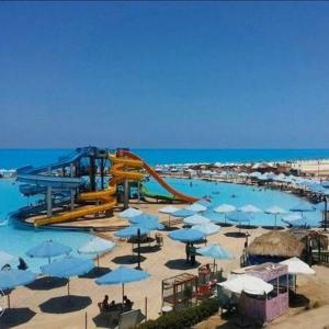 a water park with a roller coaster and a water slide at Florida Hotel North Coast in El Alamein