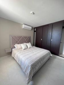 a bedroom with a large bed with two pillows at Encanto urbano con la mejor vista y ubicación ! in Cúcuta
