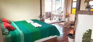 a bedroom with a green bed in a room at Yafin khaokho Camping in Ban Pa Daeng