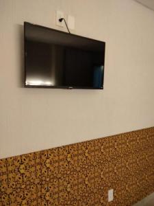 a flat screen tv hanging on a wall at Las heliconias 3 moderno loft in Oaxaca City