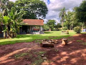 a house with a yard with trees and a building at Recanto CharaBerbel in Salto de Pirapora