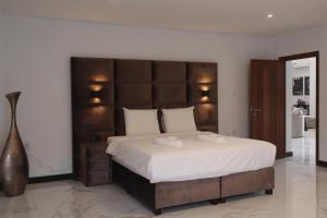 Ένα ή περισσότερα κρεβάτια σε δωμάτιο στο Empire Villa Paramaribo Noord 1 +18 φωτογραφίες