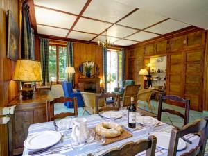 a dining room with a table and chairs at Chalet familial spacieux avec sauna au cœur du Parc du Pilat - FR-1-496-24 in Le Bessat
