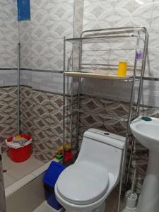 a bathroom with a white toilet and a sink at Posada Shumac Ñahui baño privado y ducha caliente in Huaraz