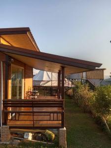 a house with a large porch with a deck at Yafin khaokho Camping in Ban Pa Daeng