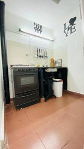 a kitchen with an oven and a counter with utensils at Camino de tango tu lugar soñado in Buenos Aires