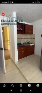 a kitchen with brown cabinets and a counter top at Apto Conjunto Residencial Lima in Montería