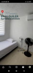a bedroom with a bed and a fan at Apto Conjunto Residencial Lima in Montería