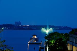 a dock with a light on the water at night at Tokigasane in Kaga