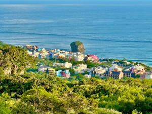 a town on a hill next to the ocean at 墾丁茉莉民宿 in Kenting