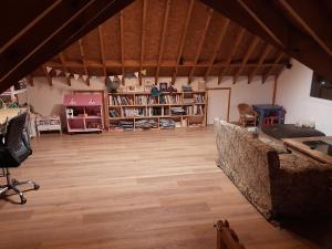 a large room with wooden floors and bookshelves at Casa Glaciar Patagonia in El Calafate
